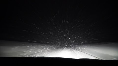 Car Driving on a Night Snowy Road Through a Blizzard Snow Storm POV Windshield View