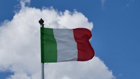 Italian flag waving quickly with a strong wind, Beautiful cloudy sky on Background. 4K Video