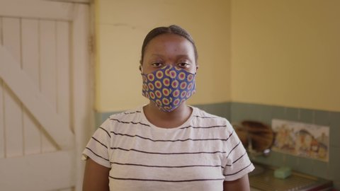 Young black South African woman wearing a protective health mask to prevent the transmission of covid-19 coronavirus.