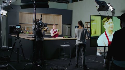 WIDE Behind the scenes of studio set, shooting TV television cooking show featuring celebrity chef, professional TV production. Shot on ARRI Alexa Mini