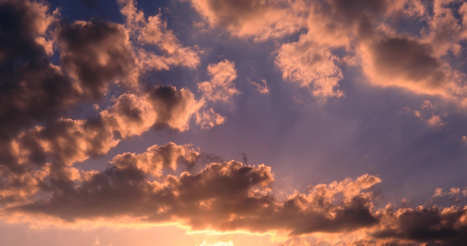 Afternoon clouds and magnificent sky in fast motion Red purple orange blue pink 4k sunset