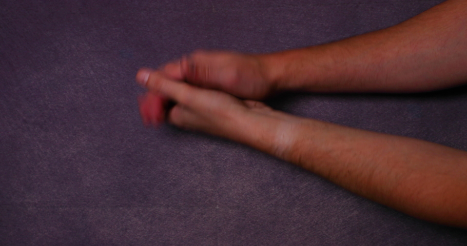 Man's hands, making applause gesture from left side on black background behind and front led light, daylight all capture in 4k 60fps slow motion movement.