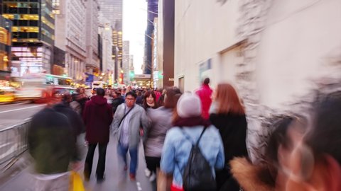 NEW YORK CITY - NOVEMBER 2016: Hyperlapse walk through crowd of people on Fifth Avenue and 57th street at dusk time in New York City, NY, USA