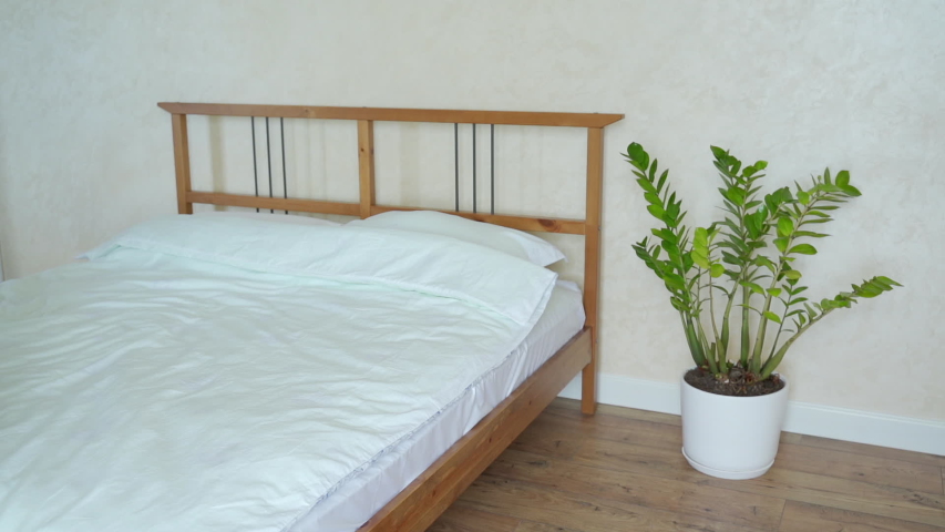 Woman falling on bed. Slow motion