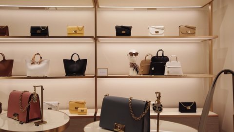 Milan, Italy, January-23,2020. Very expensive luxury shopping concept. The interior and shelves in the store of expensive women's leather handbags.