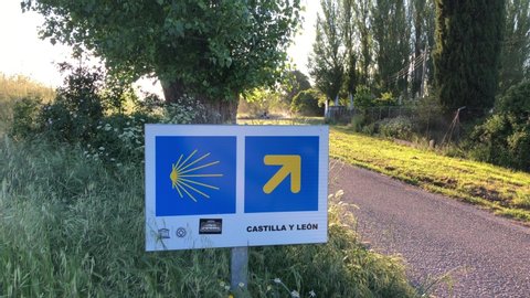 BURGOS, SPAIN - MAY 20, 2020: the yellow arrow, the sign of the Camino de Santiago in Burgos city, Castilla y León section. Cycling "El Camino Francés" Pilgrimage. Cyclists passing through Burgos.