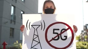 Social protests during coronavirus quarantine, protest against restriction of rights. Girl in a black mask takes part to a protest against the 5G technology and 5G-compatible antenna deployment - Powered by Shutterstock - Get 15% off with code: PIKWIZARD15