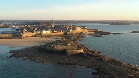 France, Bretagne, Brittany, Saint-Malo, drone aerial view of the city and National Fort at sunset (or sunrise)