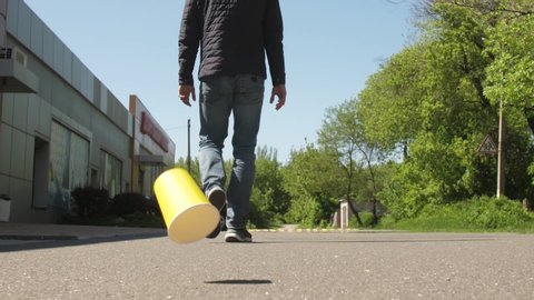 A man throws out paper cup on the ground
