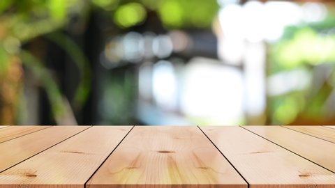 Wooden top table with bokeh light effect and blur green garden on background, blur background, 4K