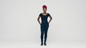 Full length of a smiling African woman standing on white background with her hand on hips. African female with a cloth wrapped on head looking at camera.
 - Powered by Shutterstock - Get 15% off with code: PIKWIZARD15