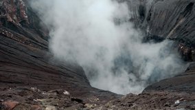 Video of the steaming active volcano crater of the Bromo on the Java island in Indonesia 