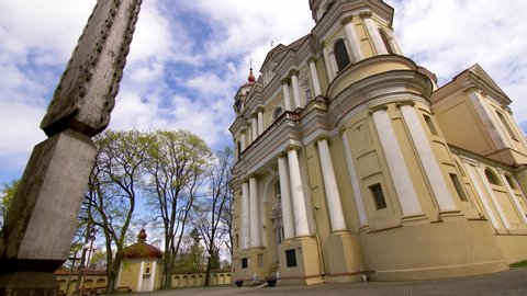 VILNIUS, LITHUANIA - APRIL 2020: Footage of the Church of St. Peter and St. Paul with wooden cross on cloudy spring day in Vilnius, Antakalnis.