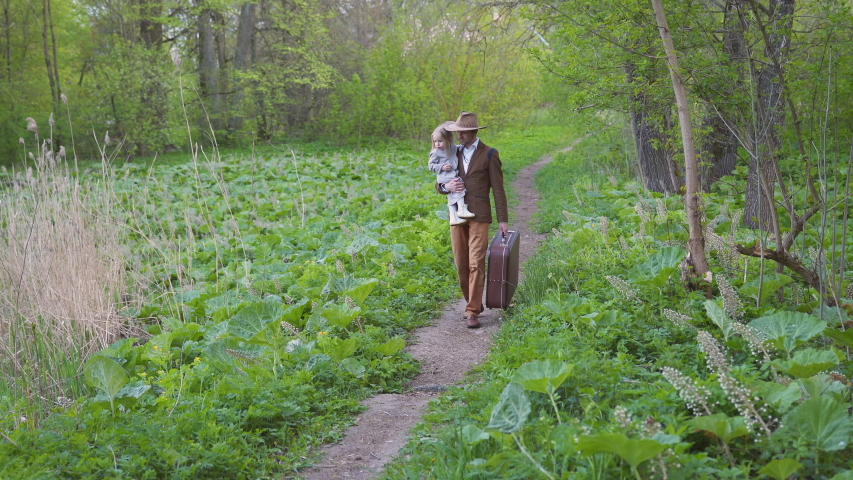 Father with a little daughter goes on a trip.