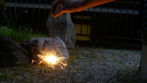 Enjoying hand-held fireworks in the garden