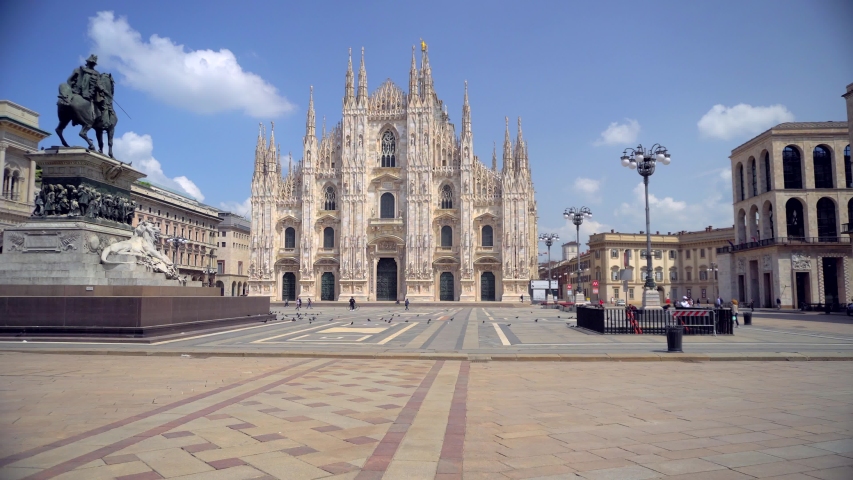 ITALY, MILAN, May 18, 2020: End of quarantine covid19 Coronavirus, new rules for the life of people in the city in protective masks. People in the city. Duomo Cathedral Square of Milano.  | Shutterstock HD Video #1052974532