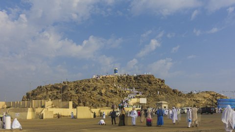 Time lapse of Muslims at Mount Arafat (or Jabal Rahmah) in Arafat, Saudi Arabia. This is the place where Adam and Eve met after being overthrown from heaven. Zoom out motion timelapse. Prores Full HD