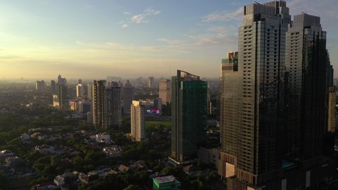 sunset sun light jakarta city downtown luxury private residence district aerial panorama 4k indonesia