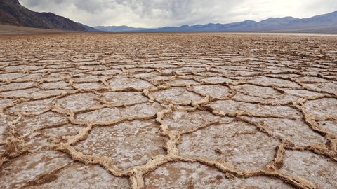 Death Valley National Park, United States. Salt pans in Badwater Basin. Mountains in background. Steadicam shot, 4K