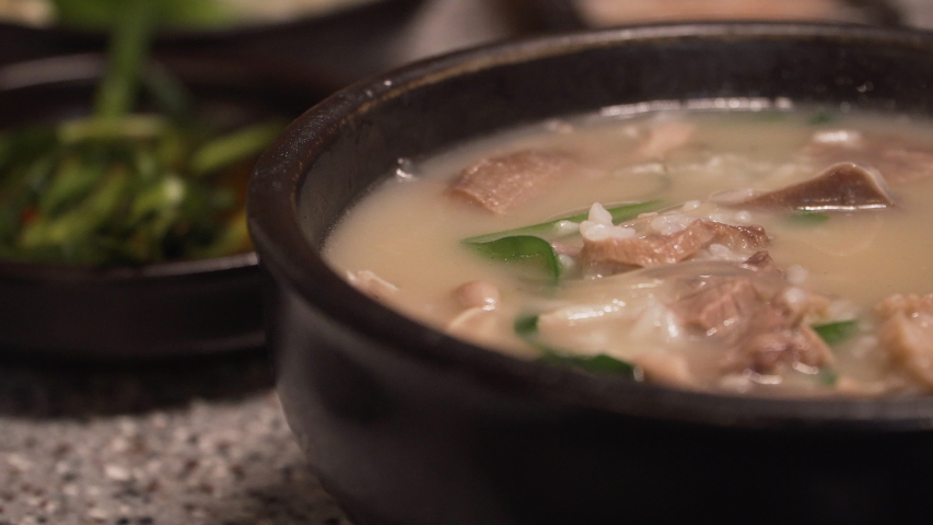 Korean traditional food, Pork and Rice Soup, Dwaeji-gukbap. It's very popular especially in Busan, South Korea. Royalty-Free Stock Footage #1053000332