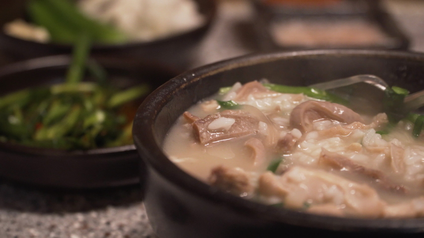 Korean traditional food, Pork and Rice Soup, Dwaeji-gukbap. It's very popular especially in Busan, South Korea. Royalty-Free Stock Footage #1053000335