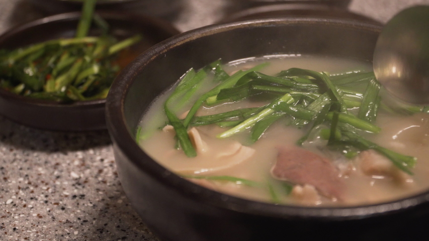 Korean traditional food, Pork and Rice Soup, Dwaeji-gukbap. It's very popular especially in Busan, South Korea. Royalty-Free Stock Footage #1053000338
