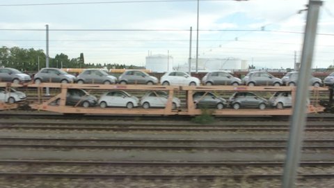 FRANCE - CIRCA 2015: A train transporting cars is seen on the rail tracks of the freight train terminal for transport across Europe and Asia