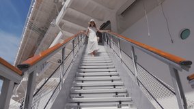 Attractive woman on the stairs. Shot on Black Magic Cinema Camera