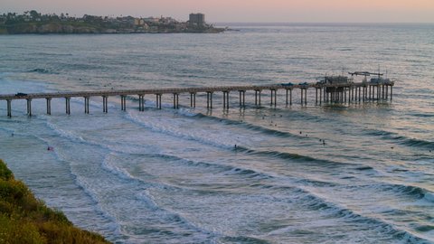 Time lapse day to night transition of Bioluminescent glowing waves at Scripps Pier in Southern California