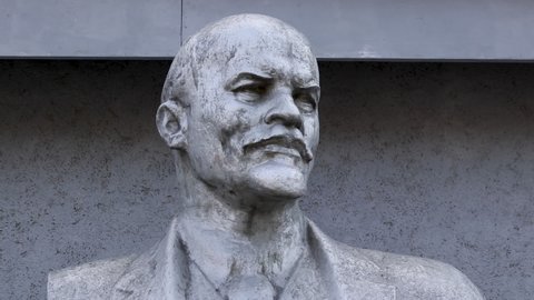 Minsk, Belarus, 05.2020 old dirty and abandoned silver lenin statue close-up in the city. sculpture of historical political leader of ussr, symbol of socialism and communism