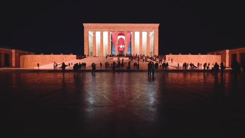 night time lapse of Anitkabir monument of Mustafa Kemal Ataturk  with turkish flag and visitors silhouette moving fast