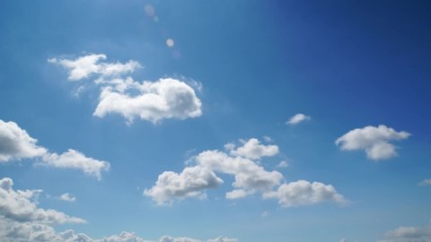 White clouds rolling in blue sky. Time lapse