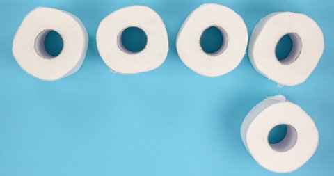 white toilet paper rolls appearing on a blue background. stop motion animation