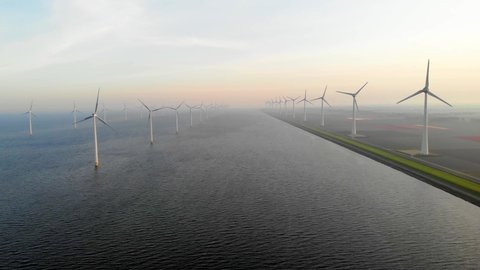 Windmill farm in the Netherlands, windmill turbine flowers and farmers working on the land, green energy in the Netherlands