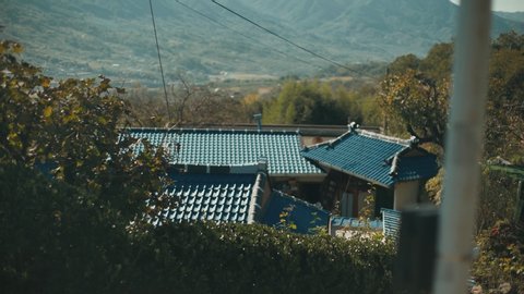 south korean typical traditional roofs in non-touristy rural residential area in Jeollanamdo with mountains and low hills around with trees in autumn 