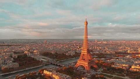 Aerial drone distant sunset view of Tour Eiffel Tower and Seine River, Paris city attractions, in France 
