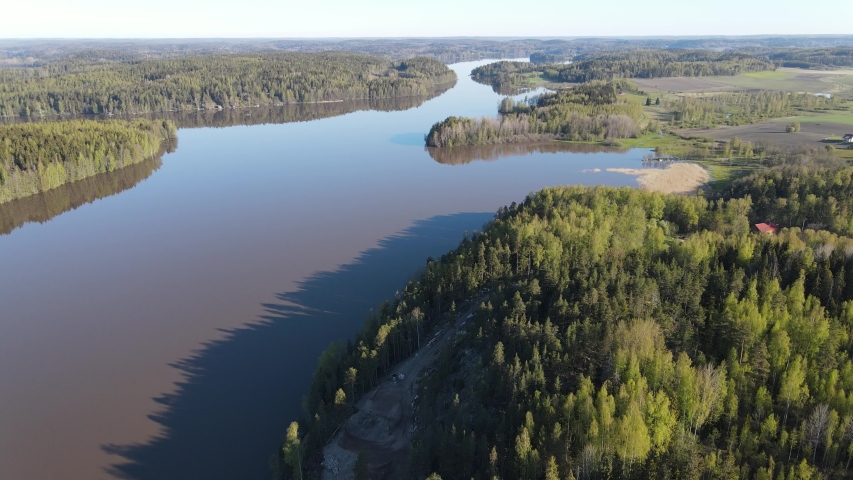 Aerial view of blue lakes and green forests on a sunny summer day in Finland