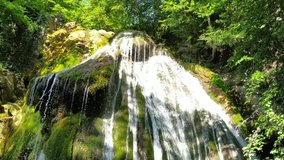 Djur-Djur waterfall in the green summer forest of Crimean peninsula in the sunny day. Beautiful landcsape.