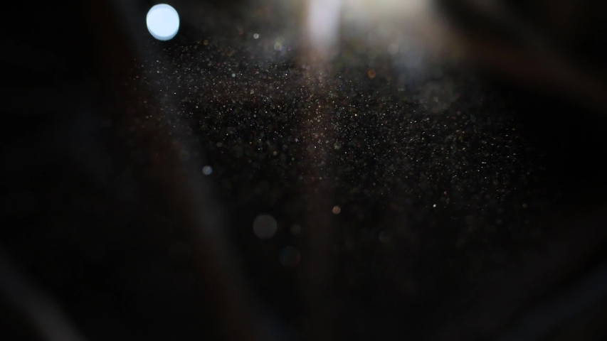 Beautiful shine Floating Dust Particles with Flare on Black Background in Slow Motion.  video of Dynamic Wind Particles In The Air With Bokeh Royalty-Free Stock Footage #1053054440
