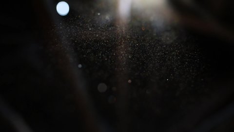 Beautiful shine Floating Dust Particles with Flare on Black Background in Slow Motion.  video of Dynamic Wind Particles In The Air With Bokeh
