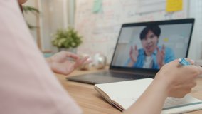 Businesswoman using laptop making video call conference with colleagues and talking, discussing business project online while she taking note on paper, write a report working from home and Remote work - Powered by Shutterstock - Get 15% off with code: PIKWIZARD15