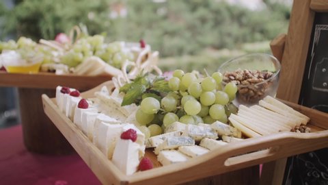 fruit platter, grape, nuts, cheese, mint, bee honey, wooden platter, cheese platter at the wedding