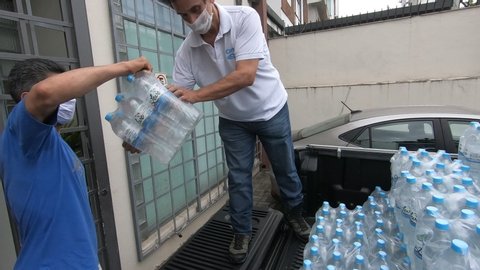São Paulo, São Paulo / Brazil - 05/23/2020: Social solidarity action - 
man carrying pickup truck with water bottles for donation to homeless people in the city of São Paulo