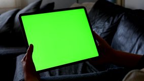 Woman holds green screen tablet in the bed 4K video