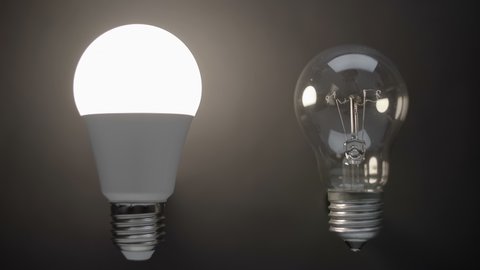 Energy-saving, eco-friendly Led bulb lamp compared to a classic glass tungsten filament lamp are lights up on a black background. Closeup