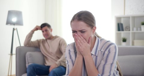 Couple having argument in living room at home. Relationship problems