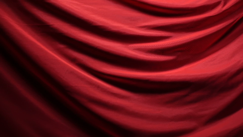 The chic and elegant texture of the moving folds of light red fabric on a black background under dramatic lighting. Slow Motion 200 FPS
 | Shutterstock HD Video #1053084089