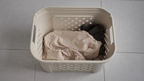 Laundry. Basket for dirty Laundry, the preparation for a big wash, top view. white bed linen is thrown into the Laundry basket