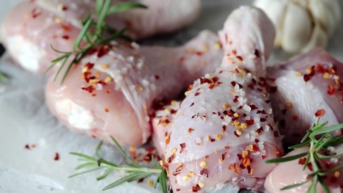 Cooking chicken legs with spices, garlic and rosemary. Cooking food concept.