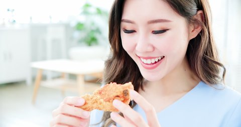 close up of asian woman eat fried chicken and junk food